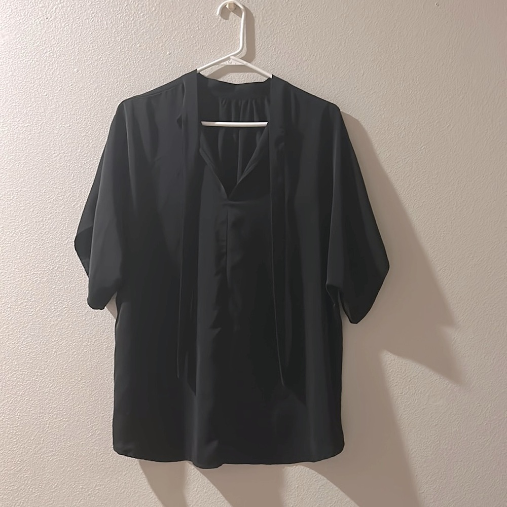 Elegant black blouse with tie neck